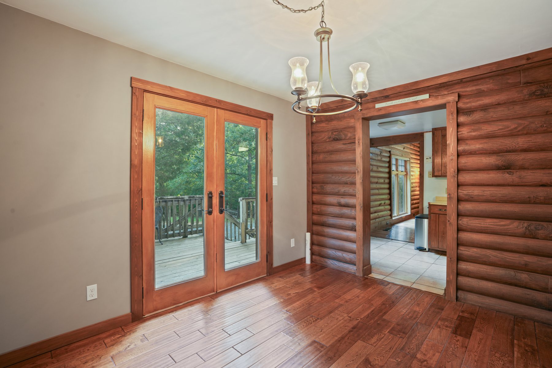 Dining area with a chandelier and french doors to the deck