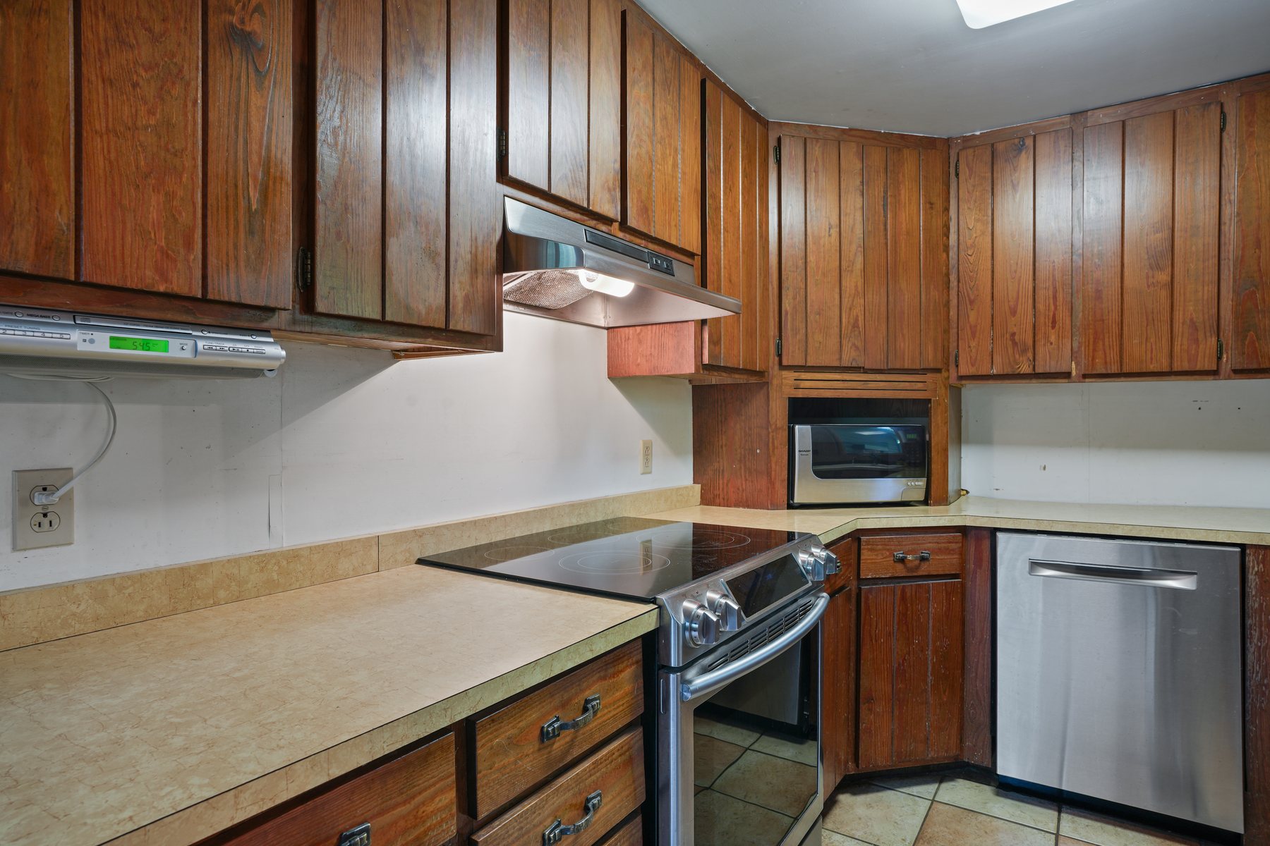 The kitchen with wood cabinetry and stainless appliances
