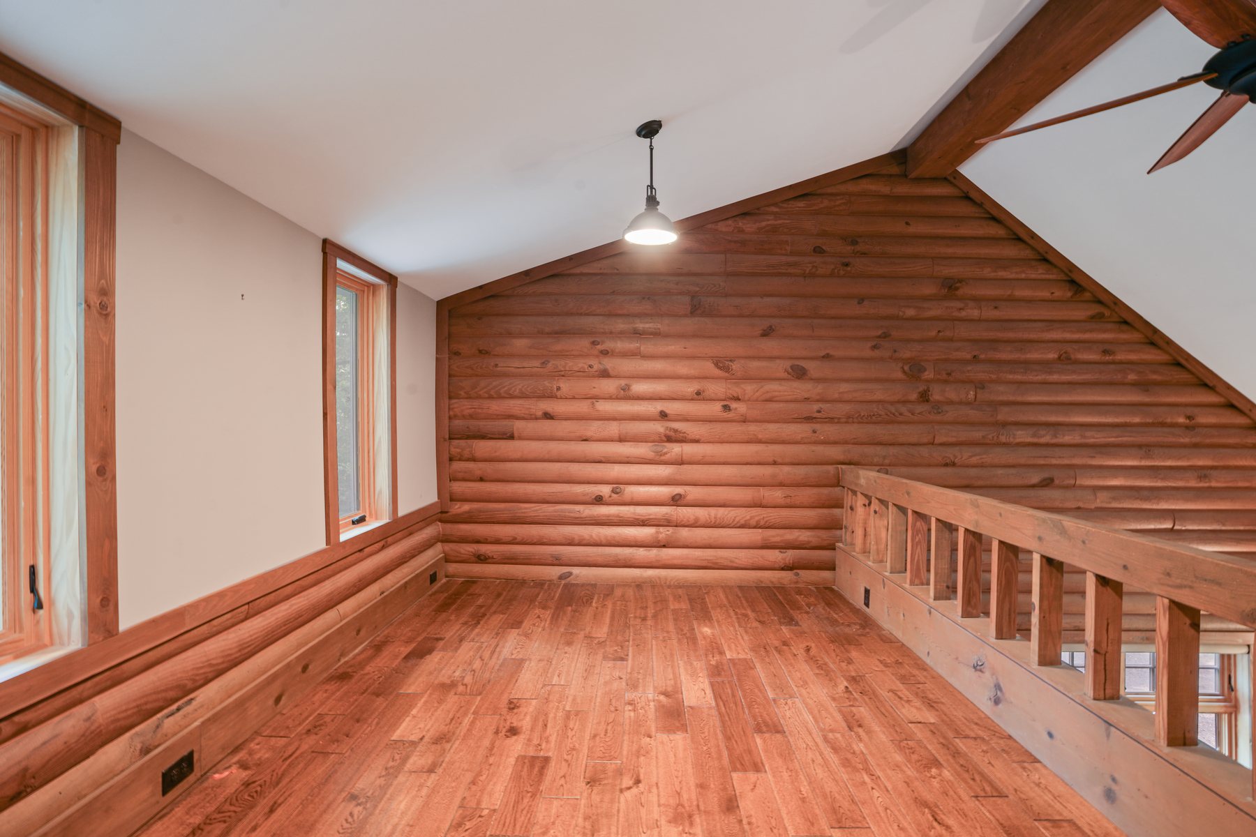 The open loft above the great room with a timber rail