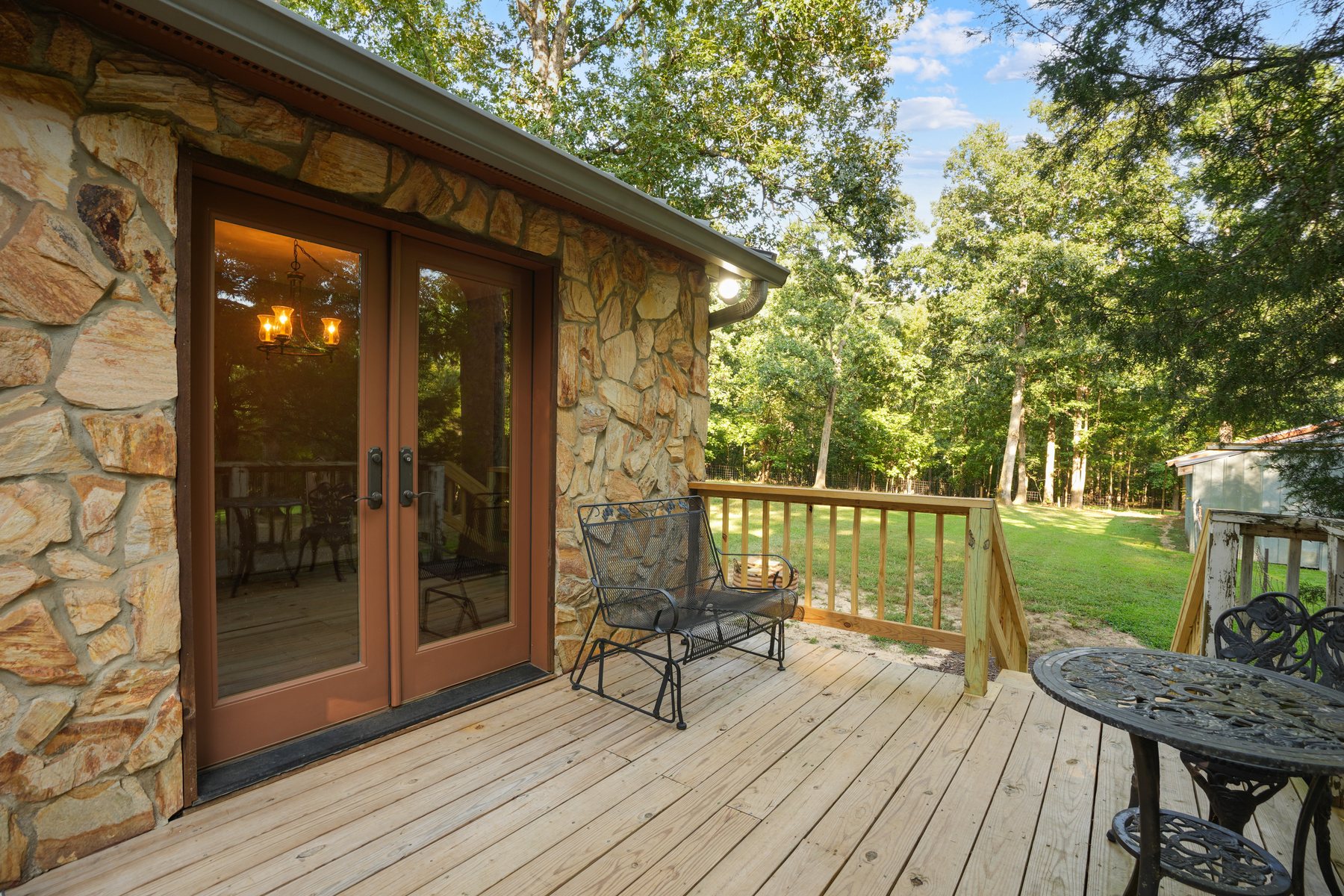 Stone-faced french doors opening onto the deck
