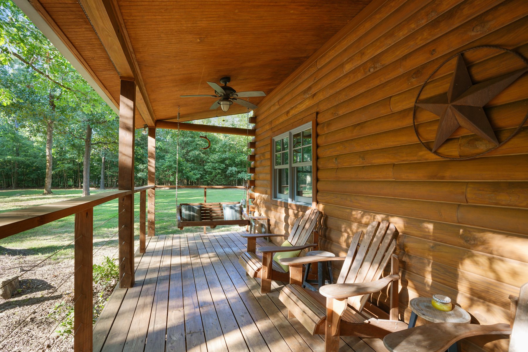 Rocking chairs and a bench under the covered porch